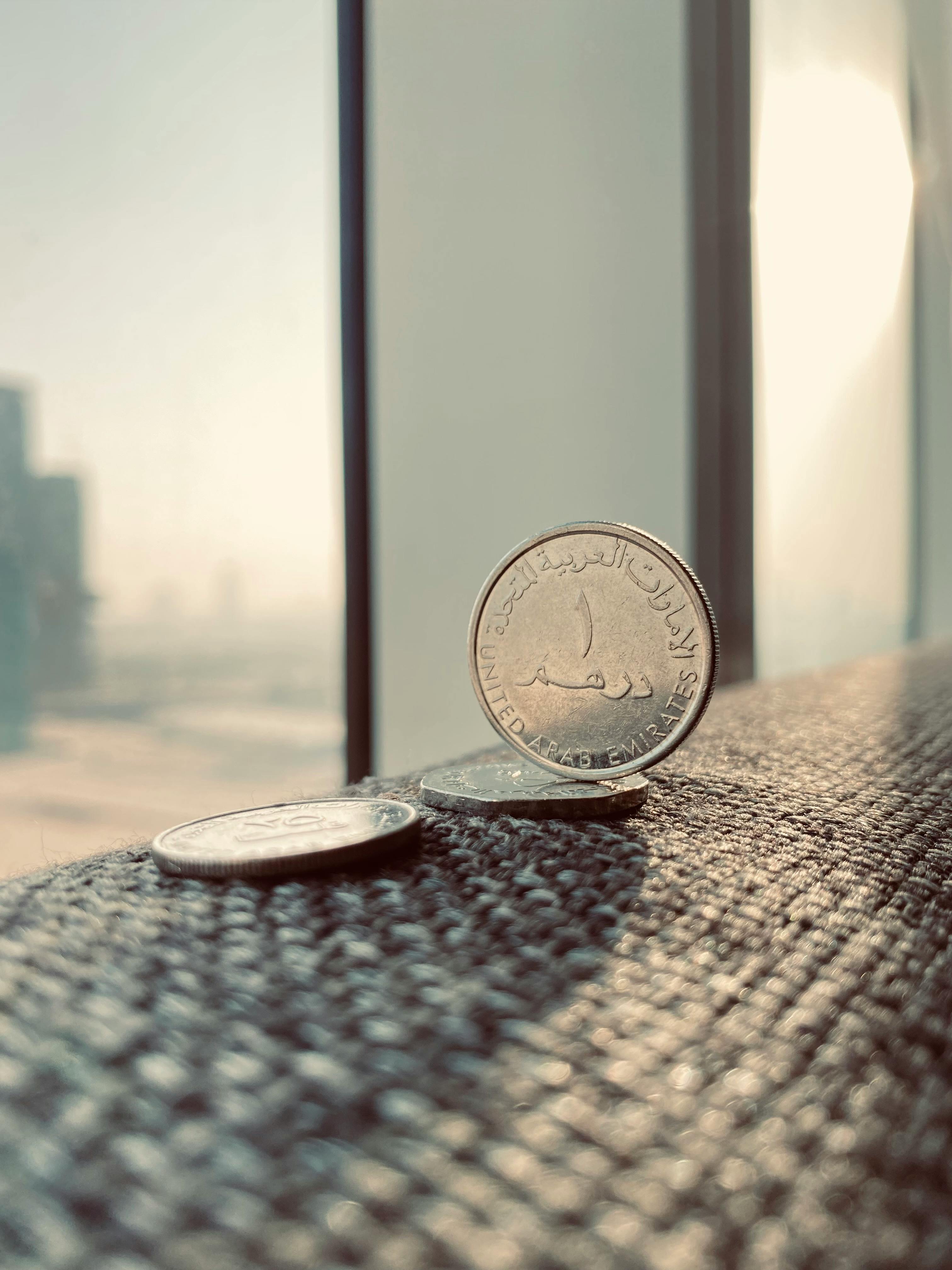 Dirham coin with Dubai skyline backdrop